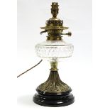 A Victorian table oil lamp with clear cut-glass reservoir on brass fluted stem & ceramic circular