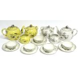 A yellow ground & silver-resist bullet shaped teapot with interwoven strap handle, a matching