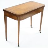 A regency satinwood card table, the rectangular fold-over top with rounded corners, & rosewood