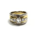 An 18ct. yellow & white gold ring set central emerald-cut diamond weighing approx. 0.65 carat,