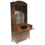 A REGENCY MAHOGANY SECRETAIRE BOOKCASE with rounded cornice, fitted four adjustable shelves enclosed