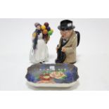 A Royal Doulton bone china figure “Biddy Penny Farthing” (HN 1843); a Royal Doulton Toby jug “