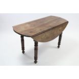 A Victorian mahogany oval drop-leaf kitchen table on turned tapered legs (slight faults), 48” x