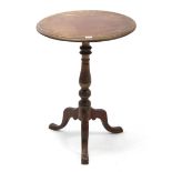 A Victorian mahogany tripod table with circular top, & on vase-turned centre column & three cabriole