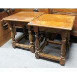 A pair of reproduction square oak occasional tables each on four baluster-turned legs with plain