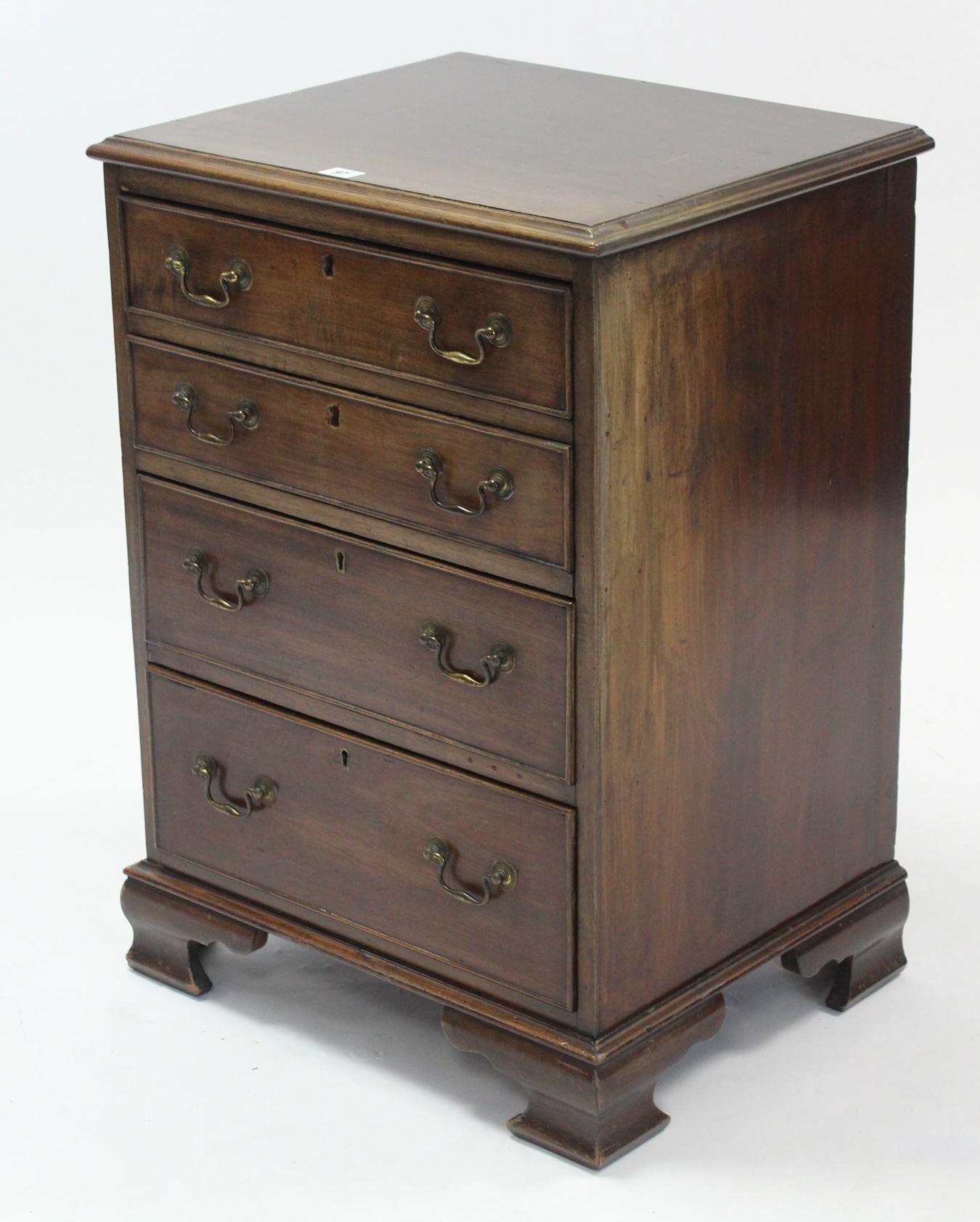 A Georgian-style mahogany small upright chest fitted four long graduated drawers with brass swan-