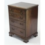 A Georgian-style mahogany small upright chest fitted four long graduated drawers with brass swan-