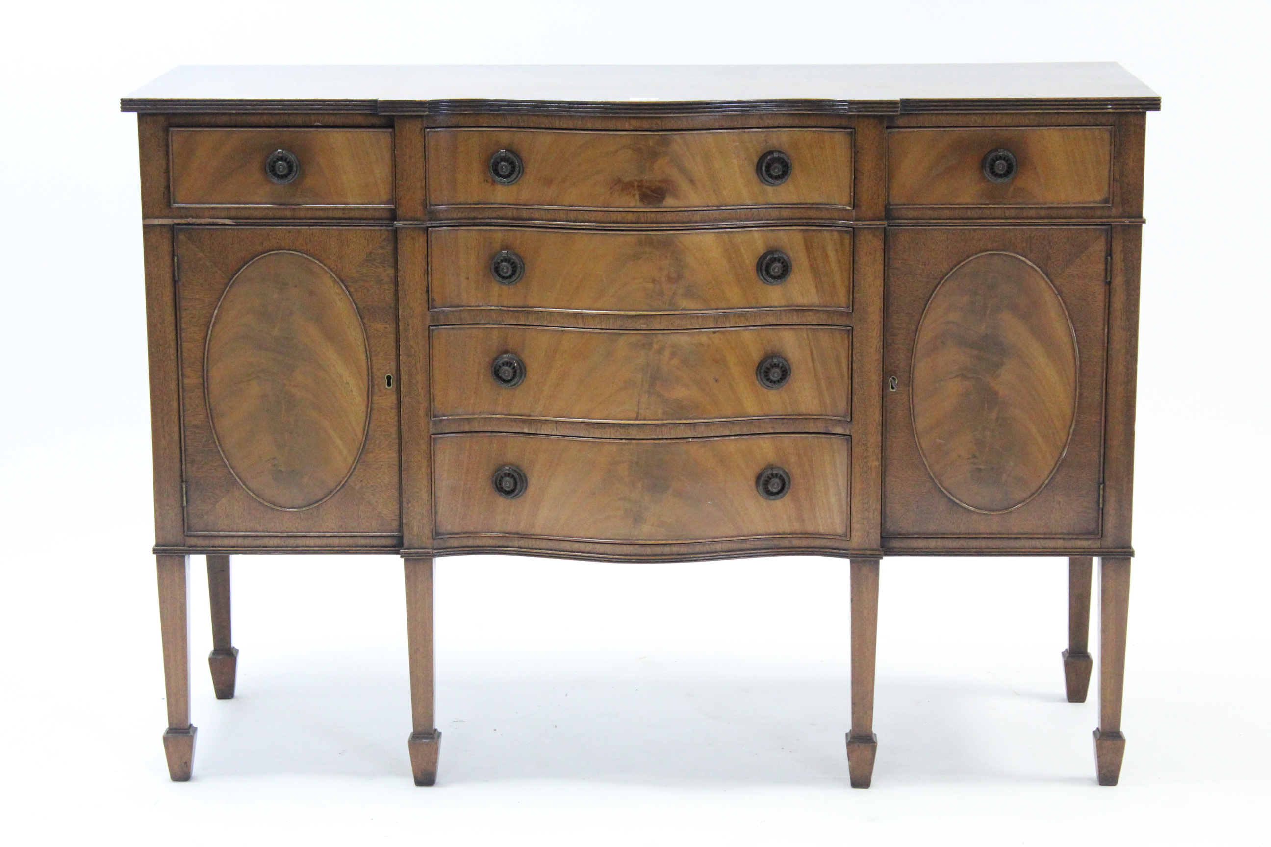 A mahogany small serpentine-front sideboard, fitted four long graduated drawers to centre flanked by