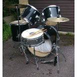 A Stagg drum kit, black finish, comprising: a 22” kick drum, a 12” tom, a 13” tom, a 16” side tom, a