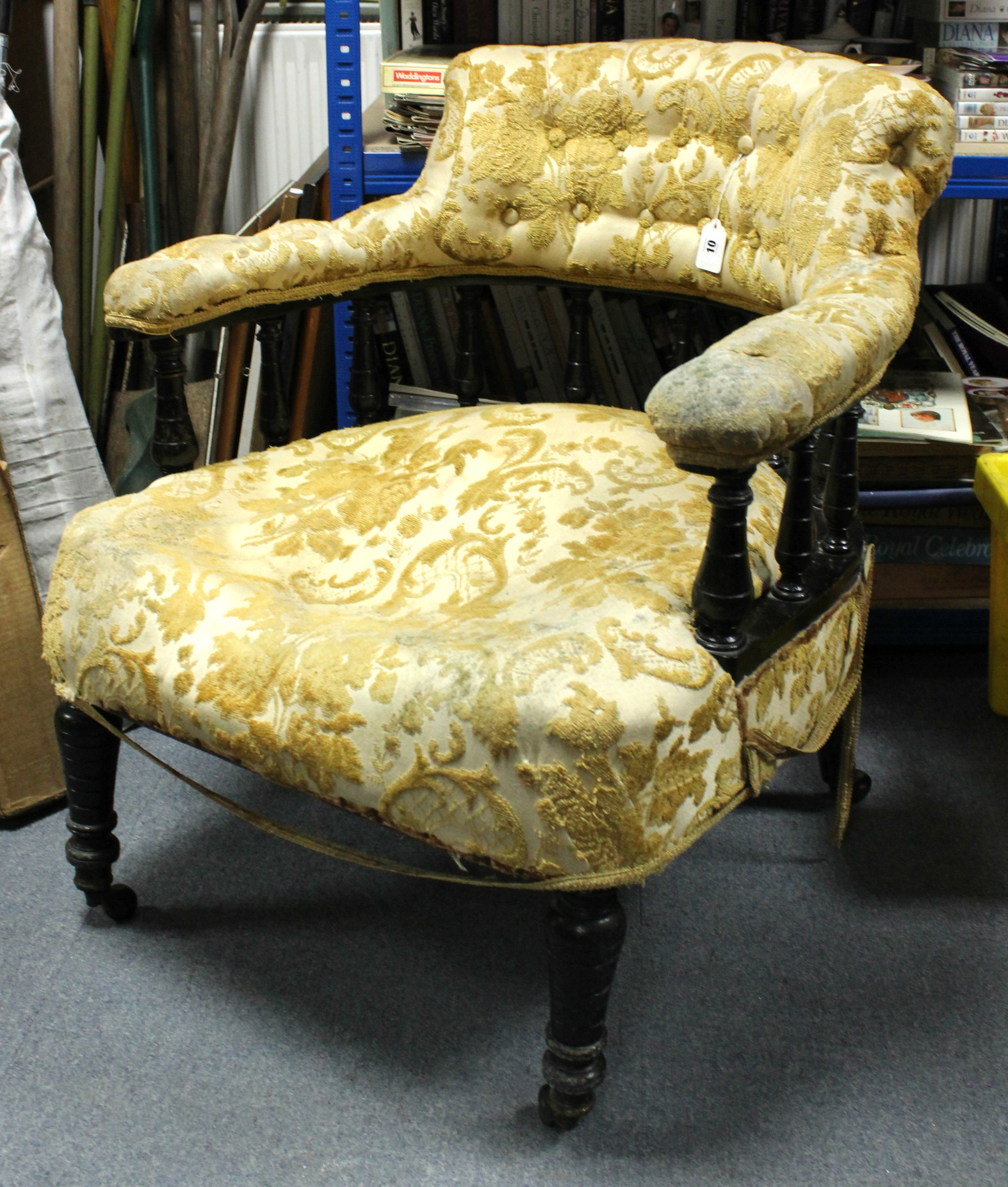 A Victorian ebonised mahogany frame tub-shaped easy chair upholstered old gold stamped floral