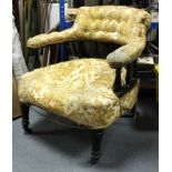 A Victorian ebonised mahogany frame tub-shaped easy chair upholstered old gold stamped floral