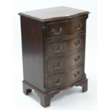 A Georgian-style mahogany small serpentine-front upright chest fitted four long drawers with brass