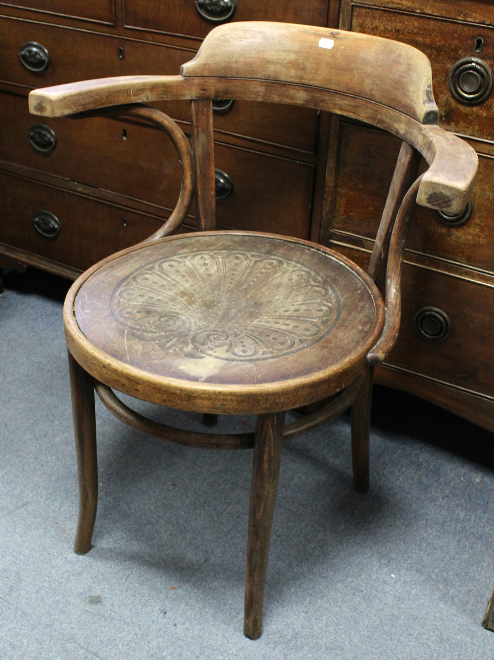 A bentwood elbow café chair with circular seat, & on shaped legs; & an oak low chest fitted two