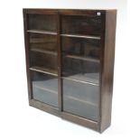 A walnut standing bookcase fitted four shelves enclosed by pair of glazed doors, 46” wide x 52½”