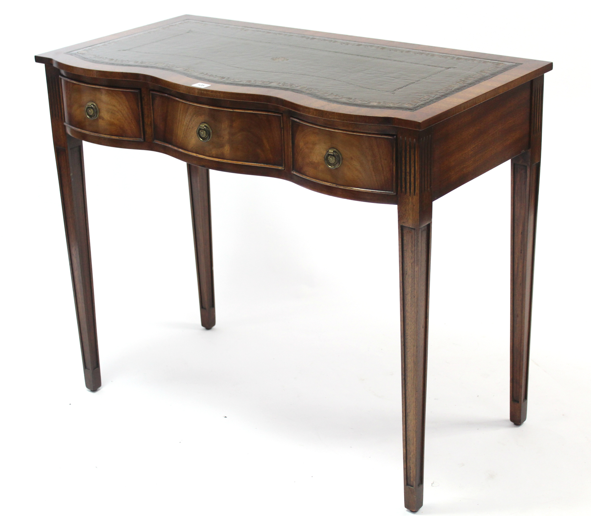 A reproduction mahogany serpentine-front writing table inset gilt-tooled green leather cloth, fitted