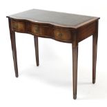 A reproduction mahogany serpentine-front writing table inset gilt-tooled green leather cloth, fitted