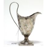 A Georgian silver helmet-shaped milk jug with reeded loop handle & on square pedestal foot, 4½” high