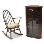 An Ercol spindle-back rocking chair; & a mahogany bow-front hanging corner cabinet 23” x 39¾”.
