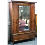 An Edwardian inlaid mahogany three-piece bedroom suite, comprising a single wardrobe, the bevelled