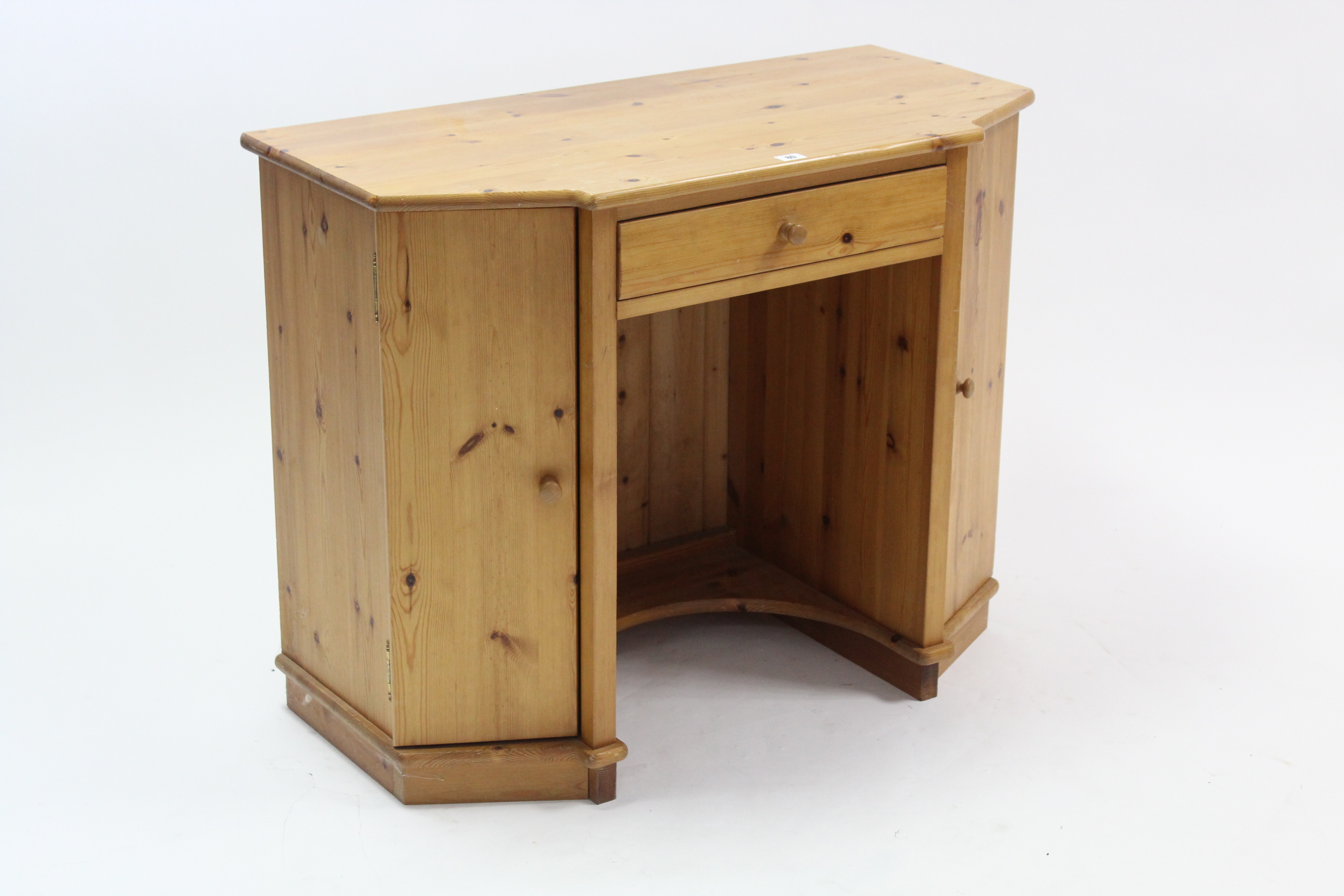 A pine child’s break-front kneehole desk fitted centre frieze drawer, & with cupboard to either