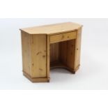 A pine child’s break-front kneehole desk fitted centre frieze drawer, & with cupboard to either