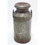 A galvanised metal milk churn “UNITED DAIRIES WHOLESALE LTD”, 28½” high.