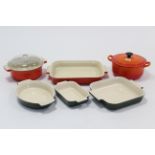 Two Le Creuset orange enamelled casserole dishes (one with replacement cover); & four Le Creuset