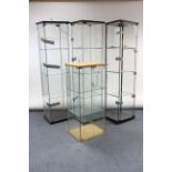 Three tall glazed shop display cabinets each fitted three plate-glass shelves, 64½” tall; & a