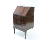 A reproduction mahogany ladies bureau with fitted interior enclosed by full-front above three long
