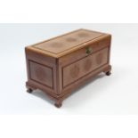 A carved camphor wood trunk with hinged lift-lid, & on bracket feet, 36” wide.