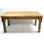 A pine farmhouse table with moulded edge & rounded corners to the rectangular top, fitted drawer