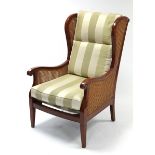 A modern mahogany-finish frame armchair inset woven-cane panels to the sides & back, with loose