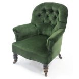A late Victorian buttoned-back easy chair upholstered green velour, & on short turned legs with