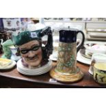 A Royal Doulton large character jug “Dick Turpin” (D6528); a Falcon Ware green glazed “Dick