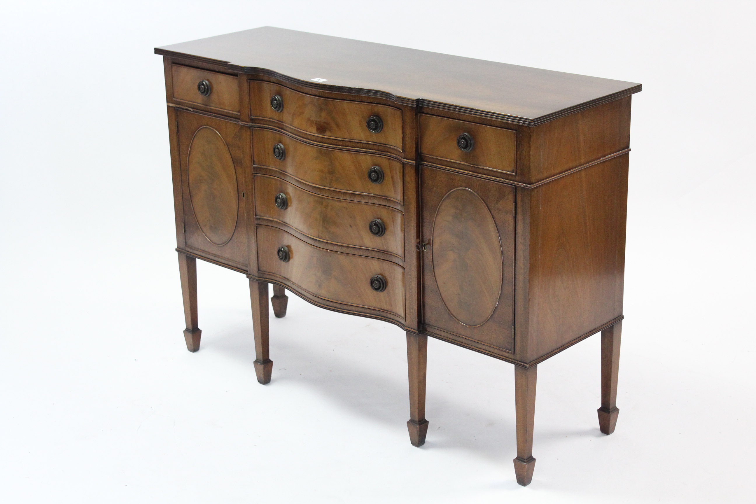 A mahogany small serpentine-front sideboard, fitted four long graduated drawers to centre flanked by - Image 2 of 2