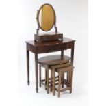 A mahogany oval swing toilet mirror, 22¾” high; together with a mahogany nest of three occasional