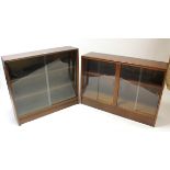 A mahogany-finish small standing bookcase with two adjustable shelves enclosed by pair of glass