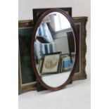An Edwardian mahogany frame oval wall mirror inset bevelled plate, 35” x 23¾”; a rectangular wall