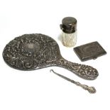 A Victorian silver embossed-back hand mirror, Birmingham 1863; a George V silver cheroot case,