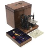 A Willcox & Gibbs “Automatic” silent sewing machine, in fitted mahogany case.