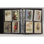 An Album of approximately two hundred & fifty postcards, early-mid 20th century – all artist drawn