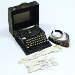 A Remington “Compact Portable” typewriter, with case; a pair of kid leather gloves; a headband, etc.