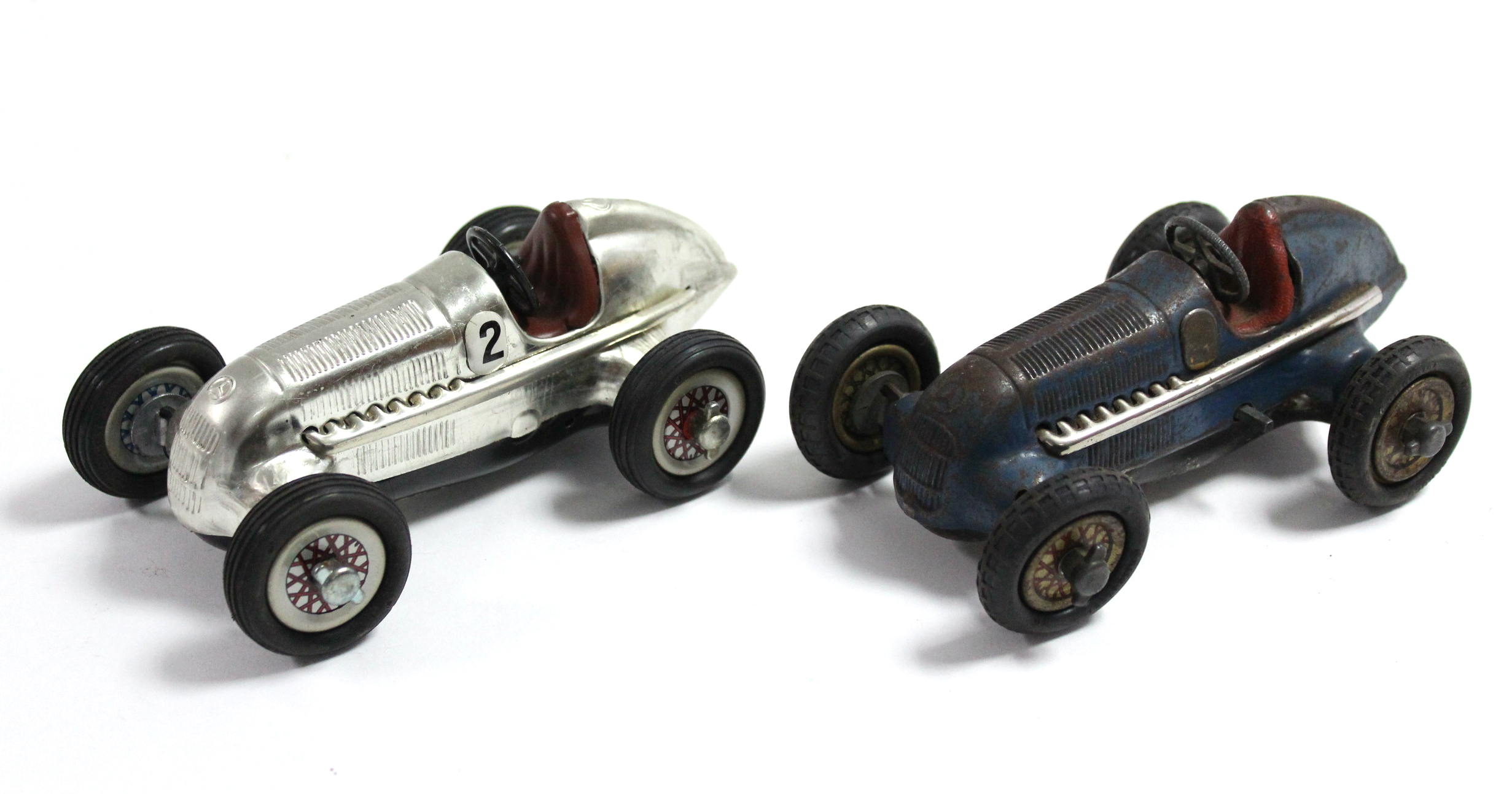 Two Schuco Studio clockwork operated tinplate racing cars, un-boxed.