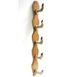 A set of five deer hoof coat hooks mounted on a shaped wooden board, 38” long.