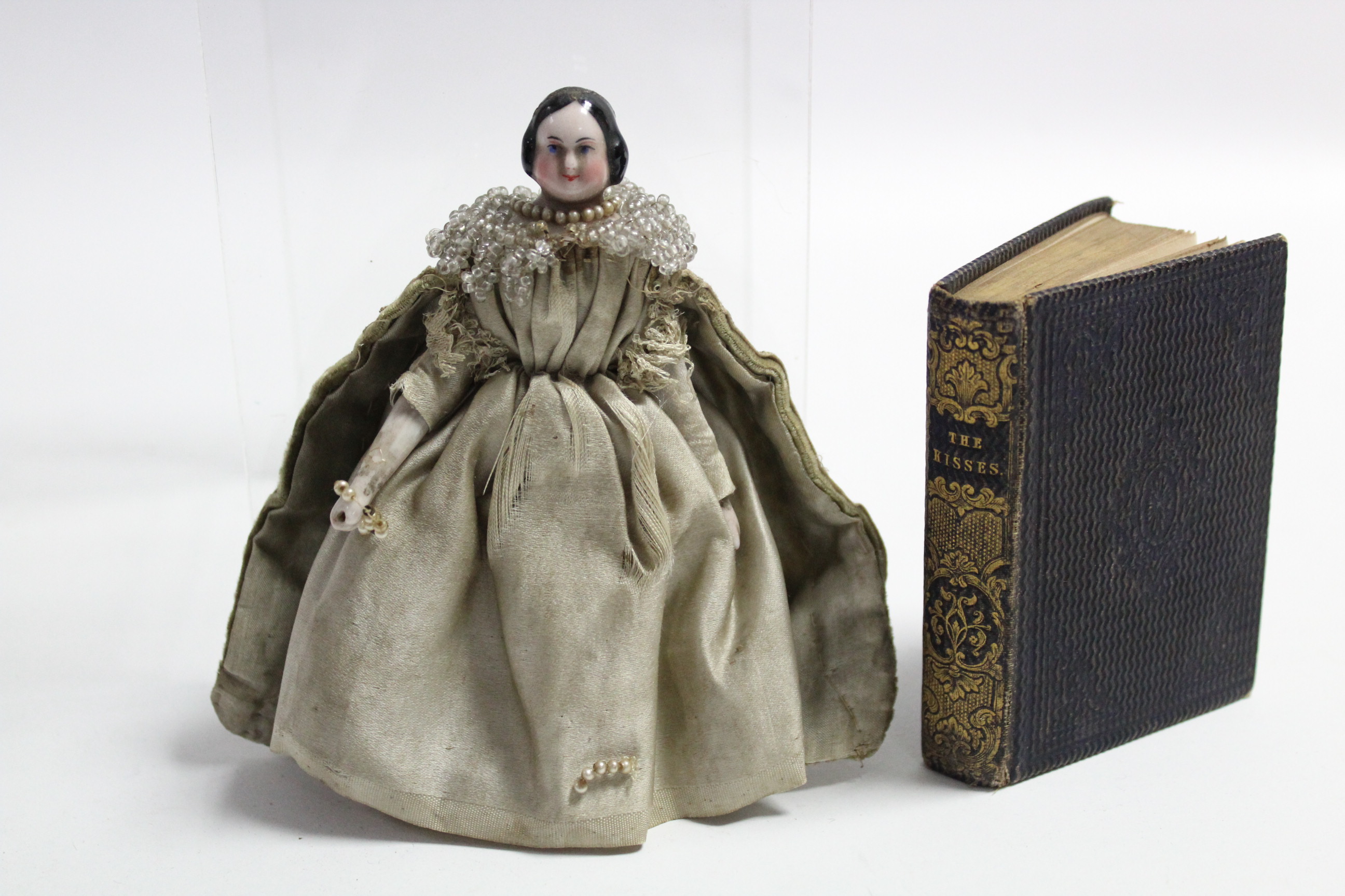 A Victorian china & wood miniature doll dressed in Elizabethan costume (lower right leg