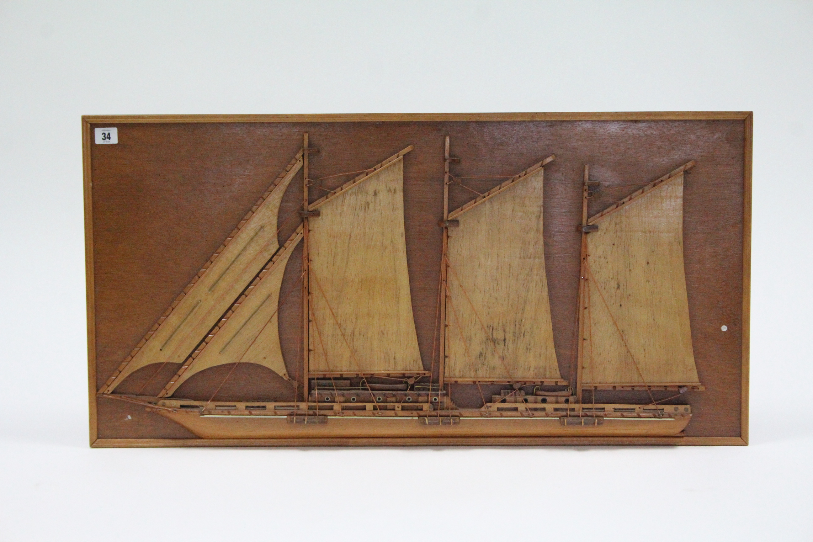 A wooden half-block model boat, 18¼” x 36¼”.