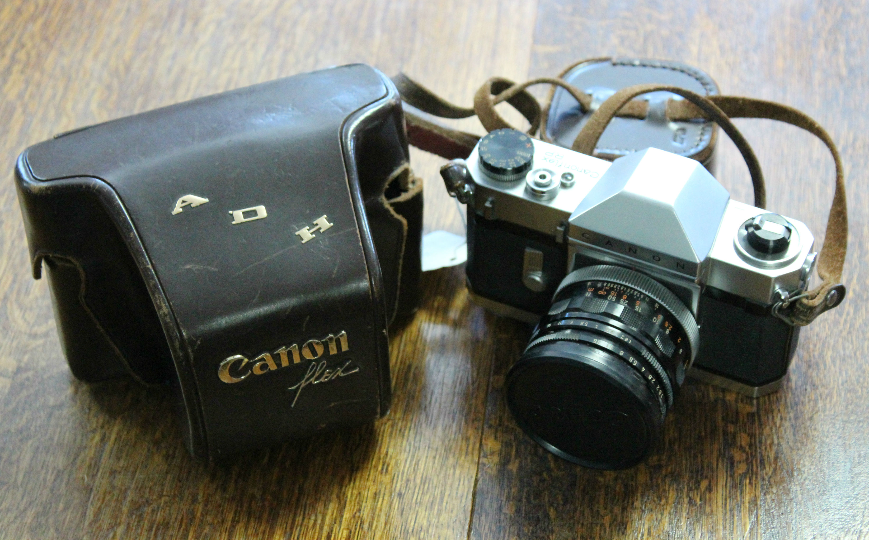 A CANON “CANONFLEX RP” 50mm camera with various accessories & leather case.