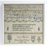 A mid-19th century needlework sampler with alphabet & numbers to the top, verse to centre &