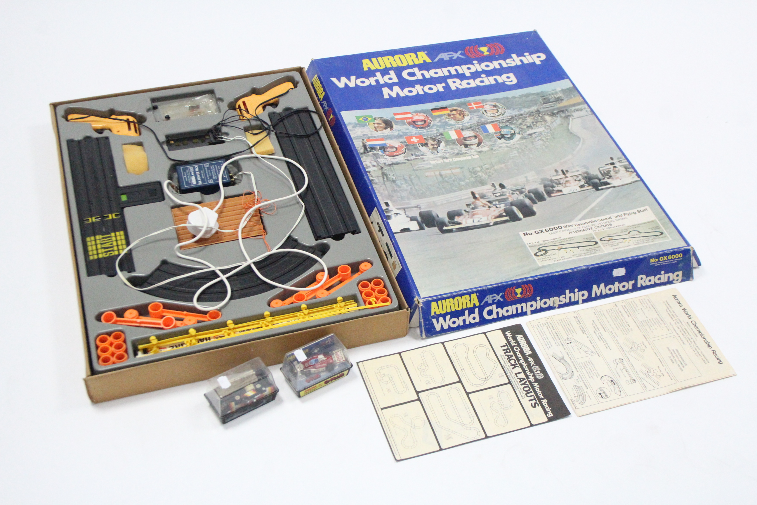 An Aurora AFX “World Championship Motor Racing” set, boxed; & two ditto racing cars “Indy