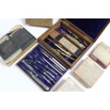 A set of steel & brass drawing implements in fitted mahogany case; a set of steel drawing